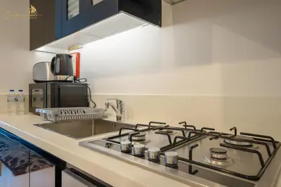 a kitchen with a stove top oven in a kitchen at Cozy Canal View Studio in Dubai