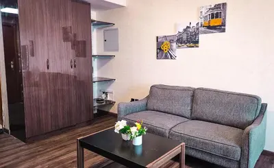a living room with a couch and a table at Upgraded Studio In Dubai Marina in Dubai