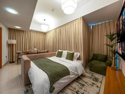 a bedroom with a large bed and a living room at Sensational direct Sea, AIN View and Palm Jumeirah in Dubai Marina in Dubai
