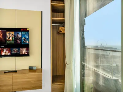 a living room with a tv and a window at Sensational direct Sea, AIN View and Palm Jumeirah in Dubai Marina in Dubai