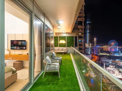 a balcony with a view of a city at night at Sensational direct Sea, AIN View and Palm Jumeirah in Dubai Marina in Dubai