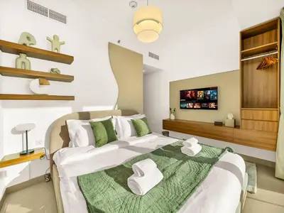 a bedroom with a large bed with towels on it at Sensational direct Sea, AIN View and Palm Jumeirah in Dubai Marina in Dubai
