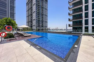 a swimming pool in a building with tall buildings at Brand New Stylish 2 BR with Balcony in Dubai