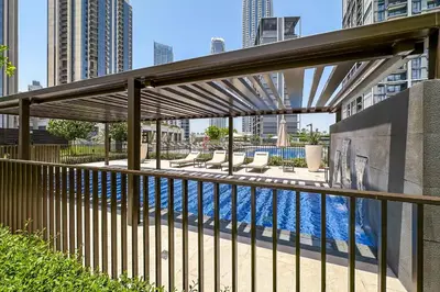 a swimming pool in the middle of a city with buildings at Brand New Stylish 2 BR with Balcony in Dubai