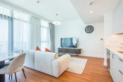 a living room with a couch and a table at Brand New Stylish 2 BR with Balcony in Dubai