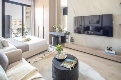 a living room with a bed and a couch and a table at Frank Porter - Bali Residences in Dubai