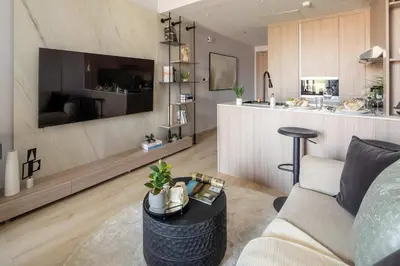 a living room with a couch and a table at Frank Porter - Bali Residences in Dubai