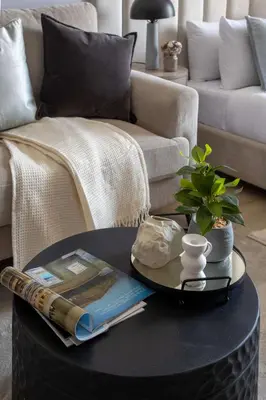 a coffee table in a living room with a couch at Frank Porter - Bali Residences in Dubai