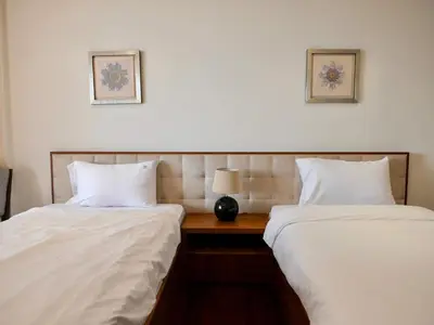 two beds sitting next to each other in a room at Oceanfront 2BR Apartment with Perfect Views in Dubai