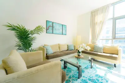 a living room with a couch and a table at AWS Holiday Homes - Charming stay near Golf Course in Dubai