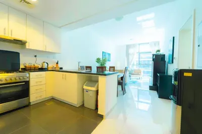 a kitchen with a counter and a stove top oven at AWS Holiday Homes - Charming stay near Golf Course in Dubai