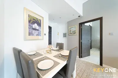 a dining room with a table and some chairs at Cayan Escape Lavish 1BR with Sea View in Dubai