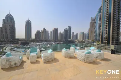 a group of chairs sitting on top of a building at Cayan Escape Lavish 1BR with Sea View in Dubai