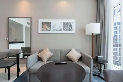 a living room with a couch and a table at Luxury Canal-View Stay in Damac Privee in Dubai