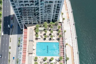 an aerial view of a building with a swimming pool at Luxury Canal-View Stay in Damac Privee in Dubai