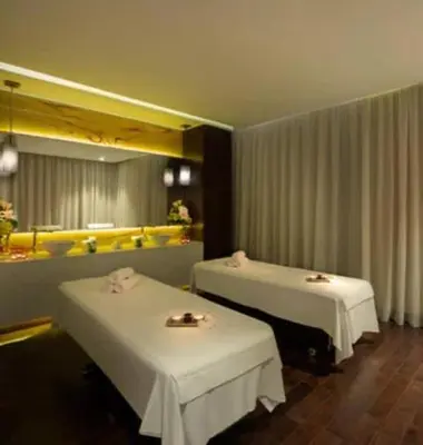 a restaurant with two beds with white tables in it at Luxury Canal-View Stay in Damac Privee in Dubai