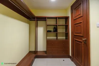 a closet in a room with a wooden door at Clever Guest 030 Golden Mile 6 in Dubai