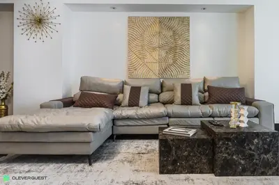 a living room with a couch and a coffee table at Clever Guest 030 Golden Mile 6 in Dubai