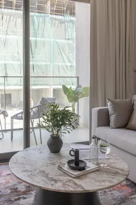 a living room with a coffee table and a couch at Frank Porter - MYKA Residence in Dubai