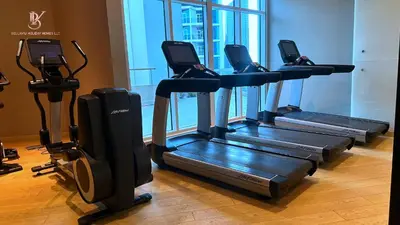 a row of treadmills in a gym at Bellaviu Holiday Homes Peaceful Escape at DAMAC Maison Prive in Dubai