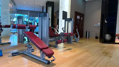 a gym with lots of exercise equipment in a building at Bellaviu Holiday Homes Peaceful Escape at DAMAC Maison Prive in Dubai