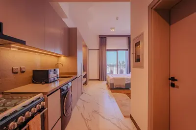 a kitchen with a sink and a stove at Voyage Studio In Mag City in Dubai