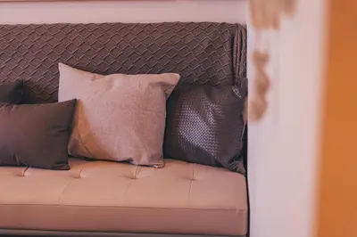 a couch with several pillows on it at Voyage Studio In Mag City in Dubai