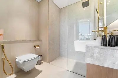 a bathroom with a toilet and a shower and a sink at Chic Studio with Balcony and Gym at JVC in Dubai