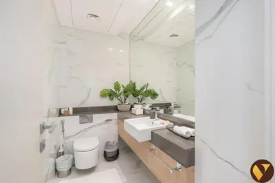 a white bathroom with a sink and a mirror at Vogue JLT Banyan Tree Residences Hillside, near Marina and JBR, Two Bedroom Apartment with Balcony and City View, Access to all Amenities in Dubai