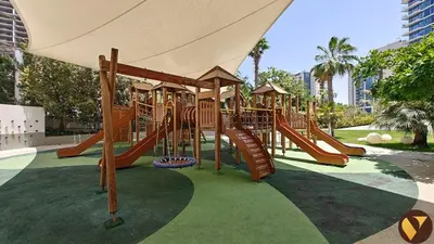 a playground with a slide in a park at Vogue JLT Banyan Tree Residences Hillside, near Marina and JBR, Two Bedroom Apartment with Balcony and City View, Access to all Amenities in Dubai