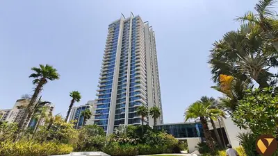 a tall building with palm trees in front of it at Vogue JLT Banyan Tree Residences Hillside, near Marina and JBR, Two Bedroom Apartment with Balcony and City View, Access to all Amenities in Dubai