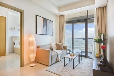a living room with a couch and a view of the ocean at Aykon City 2BR Luxury Stay Close to Downtown in Dubai