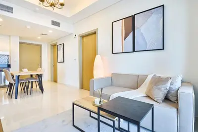 a living room with a couch and a table at Aykon City 2BR Luxury Stay Close to Downtown in Dubai