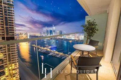 a room with a view of a city at night at LUX The Marina Vista Beachfront Suite 5 in Dubai