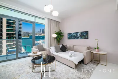 a living room with a couch and a large window at LUX The Marina Vista Beachfront Suite 5 in Dubai