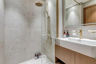 a bathroom with a shower and a sink at Luxury Studio with Jacuzzi & Canal Views in Dubai