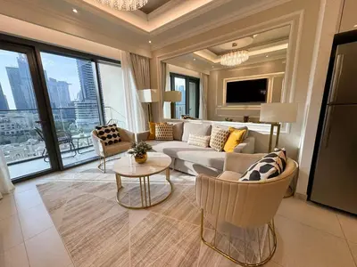 a living room with a couch and a table at Kensington - 2BR Burj Royale 5 min Dubai Mall in Dubai