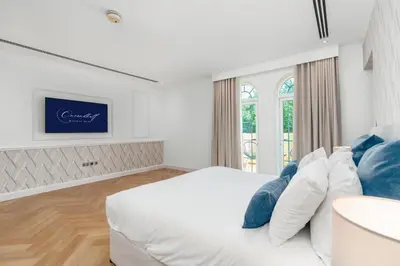 a bedroom with a white bed with blue pillows at Elite Villa in Dubai in Dubai
