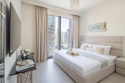 a hotel room with a bed and a large window at Frank Porter - Forte Tower 1 in Dubai
