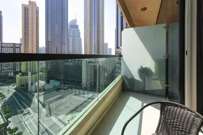 a balcony with a chair and a view of the city at studio in downtown Damac upper crest next to dubai mall in Dubai