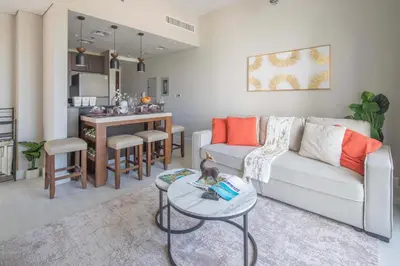 a living room with a couch and a table at Frank Porter - Kappa Acca 3 in Dubai