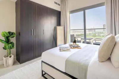 a bedroom with a large bed and a large window at Frank Porter - Kappa Acca 3 in Dubai