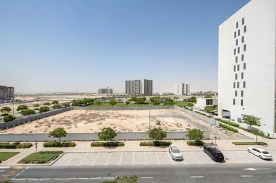 an empty parking lot in a city with buildings at Frank Porter - Kappa Acca 3 in Dubai