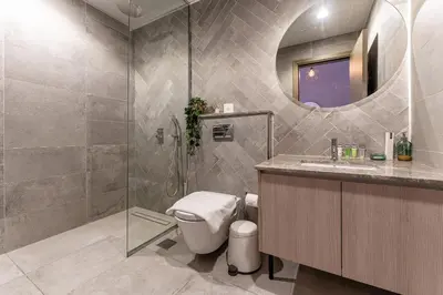 a bathroom with a shower and a toilet and a sink at HAVN - Studio in La Riviera Azure JVC, Pool View in Dubai