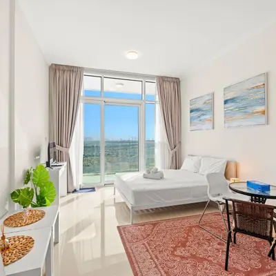 a white bedroom with a bed and a large window at Damac Hills Carson A Monthly Stay - Pay 28, Stay 30 in Dubai