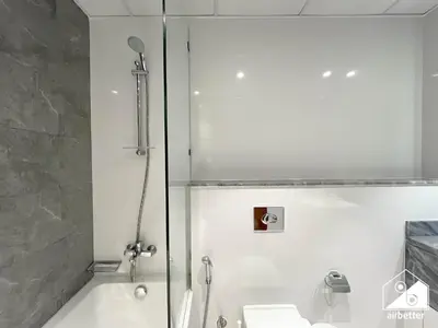 a bathroom with a shower and a sink at Business Bay 2BR in Amna Tower & Canal Views in Dubai