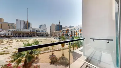 a balcony with a view of a beach and buildings at Signature Livings - Bright Studio in JVC in Dubai