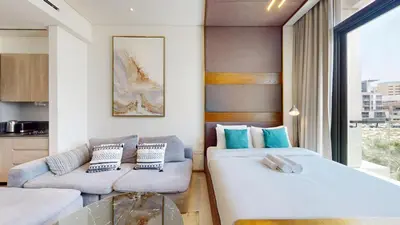 a living room with two couches and a couch at Signature Livings - Bright Studio in JVC in Dubai