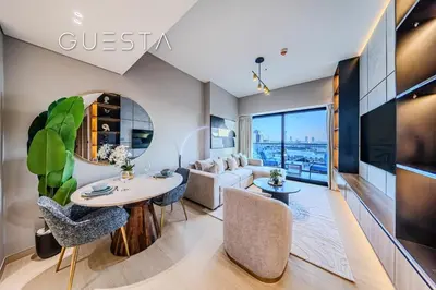 a living room with a couch and a table at Binghatti Emerald, Jumeirah Village Circle in Dubai