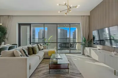 a living room with a couch and a table at Tranquil & Modern 2BR - Vida Residence Creek Beach in Dubai